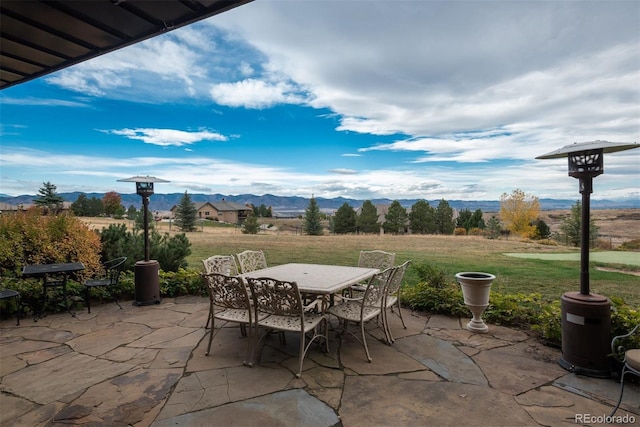 view of patio / terrace featuring outdoor dining area and a mountain view