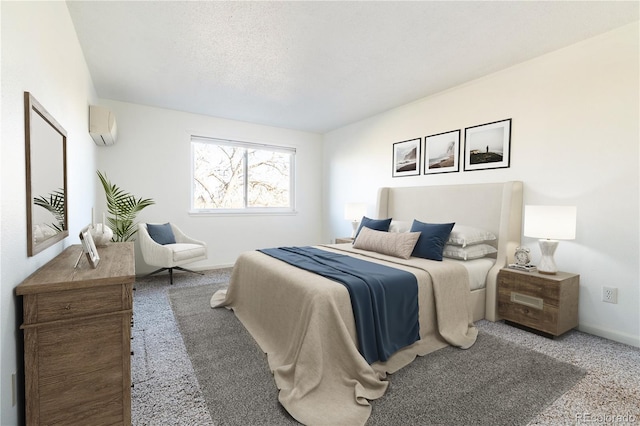 carpeted bedroom featuring a wall mounted air conditioner and a textured ceiling