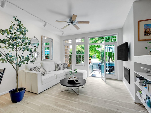 2716 W Greens Dr, Littleton, CO 80123 - living area with healthy amount of natural light, a ceiling fan, rail lighting, and light wood-style flooring