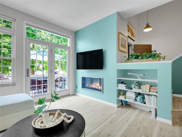 2716 W Greens Dr, Littleton, CO 80123 - living area with wood finished floors, a glass covered fireplace, and baseboards