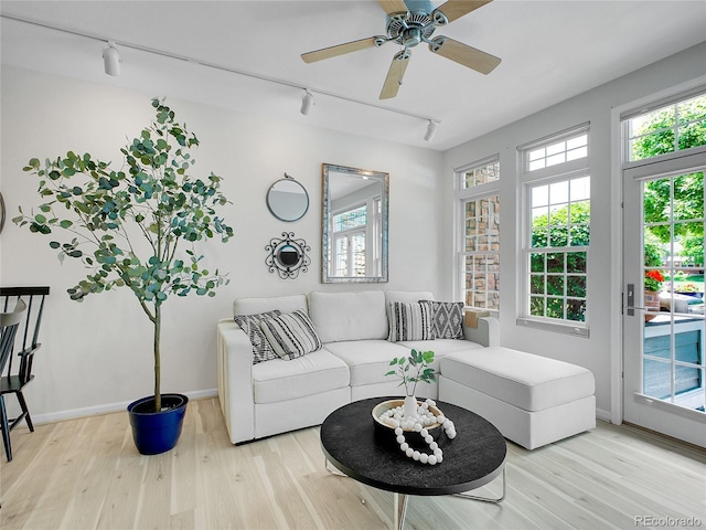 2716 W Greens Dr, Littleton, CO 80123 - living room with track lighting, wood finished floors, baseboards, and ceiling fan