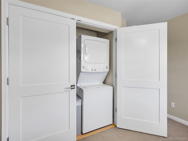 2716 W Greens Dr, Littleton, CO 80123 - laundry room featuring stacked washer and clothes dryer and baseboards