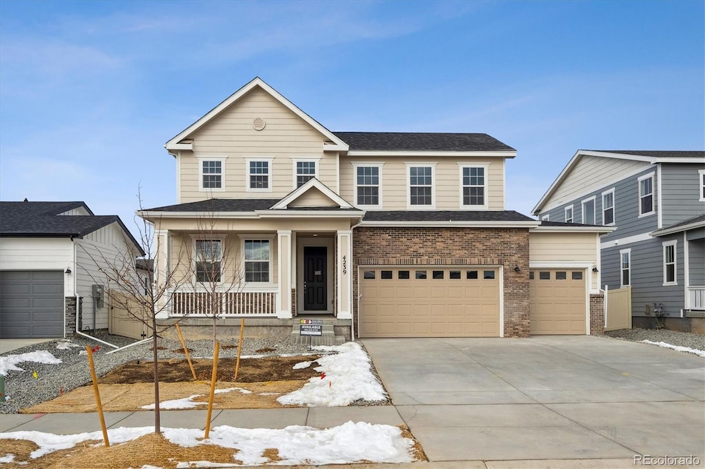 view of front of property with covered porch and a garage