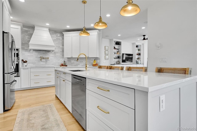 12408 W 83rd Ave, Arvada, CO 80005 - kitchen featuring stainless steel appliances, custom range hood, a sink, light countertops, and ceiling fan