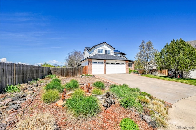 12408 W 83rd Ave, Arvada, CO 80005 - traditional home with concrete driveway and brick siding