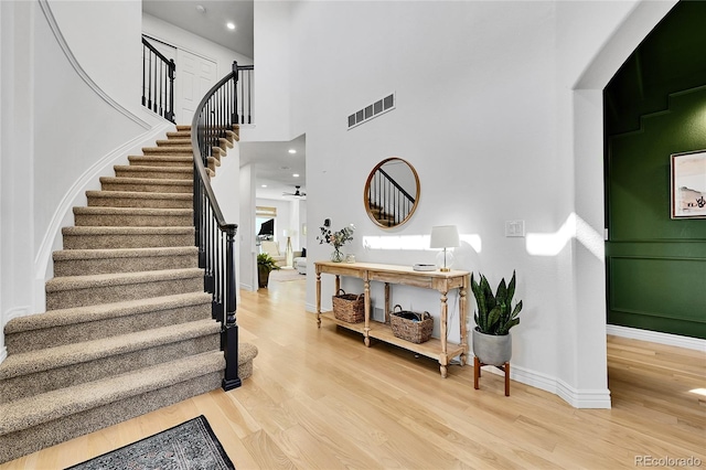 12408 W 83rd Ave, Arvada, CO 80005 - stairway featuring wood finished floors, baseboards, recessed lighting, and a high ceiling