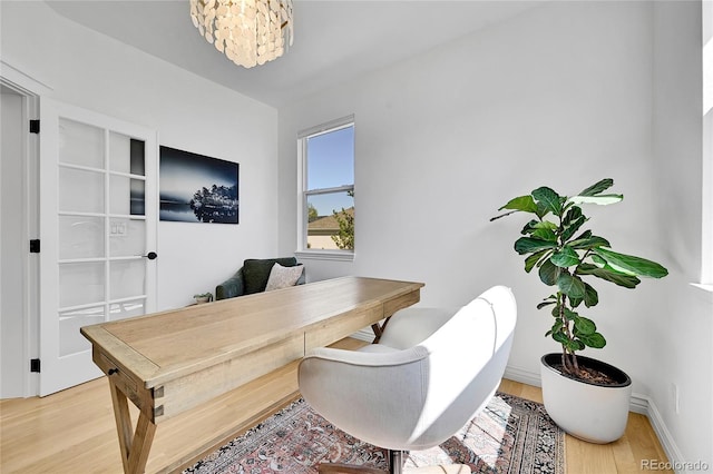12408 W 83rd Ave, Arvada, CO 80005 - home office featuring light wood-type flooring, baseboards, and a chandelier