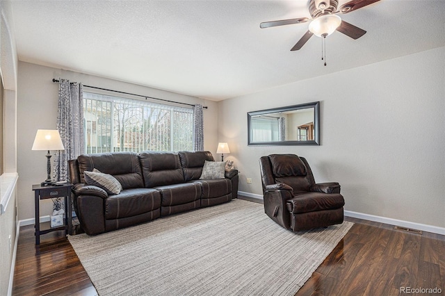 living area featuring baseboards, wood finished floors, and ceiling fan