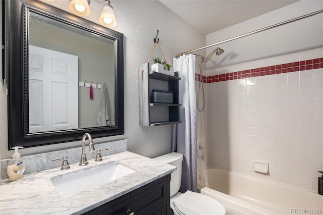 bathroom with a textured wall, toilet, vanity, and shower / bath combo with shower curtain