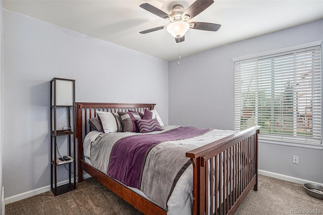 carpeted bedroom featuring baseboards and a ceiling fan