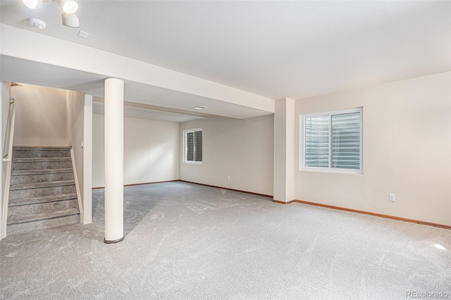 basement with carpet, baseboards, and stairs