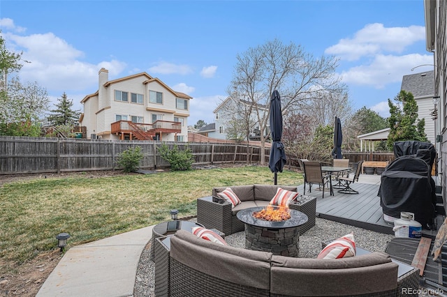 view of patio with a deck, outdoor dining space, and an outdoor living space with a fire pit