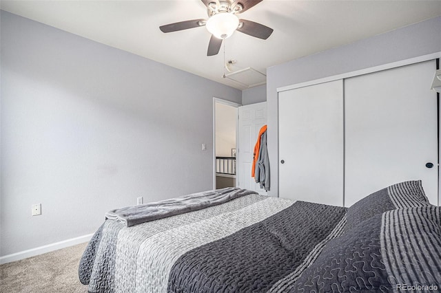 bedroom featuring carpet, baseboards, ceiling fan, a closet, and attic access