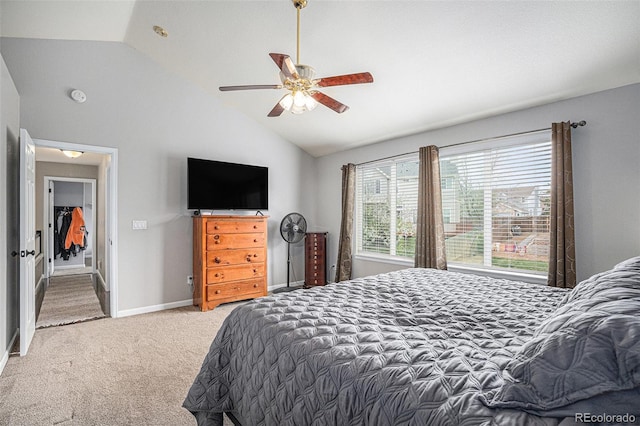 carpeted bedroom featuring vaulted ceiling, baseboards, and a ceiling fan