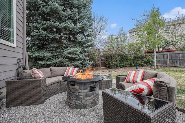 view of patio / terrace featuring an outdoor living space with a fire pit and a fenced backyard