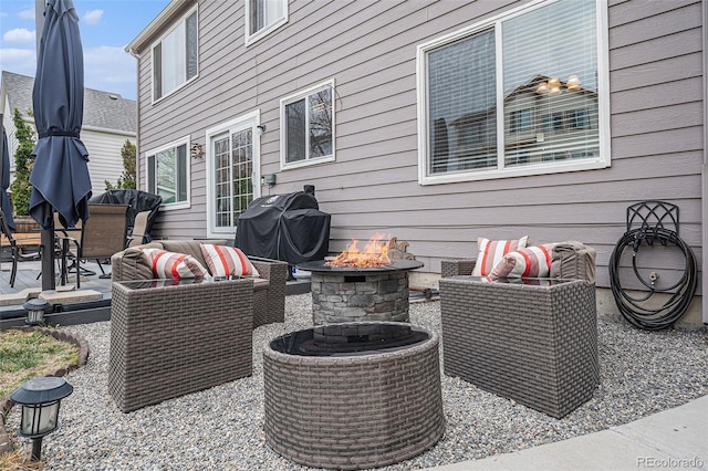 view of patio / terrace with an outdoor fire pit, area for grilling, and a wooden deck