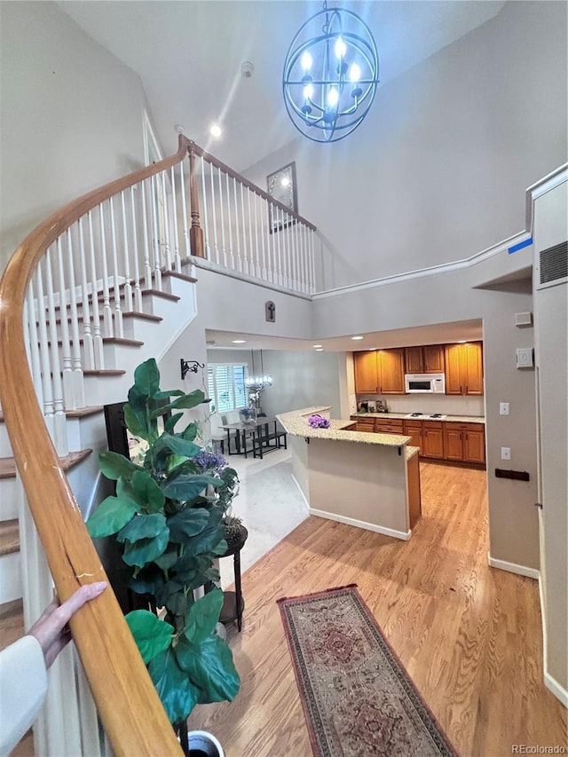 interior space featuring a chandelier, hardwood / wood-style floors, and a high ceiling