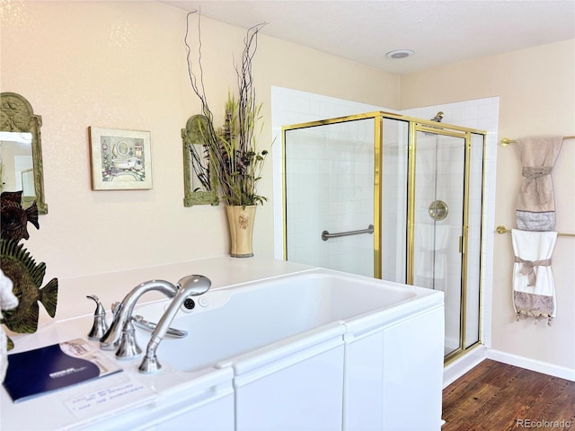 bathroom featuring an enclosed shower and wood-type flooring