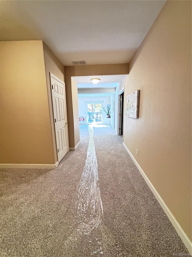 hallway featuring carpet