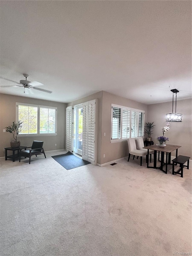 living room featuring ceiling fan, a healthy amount of sunlight, and carpet floors