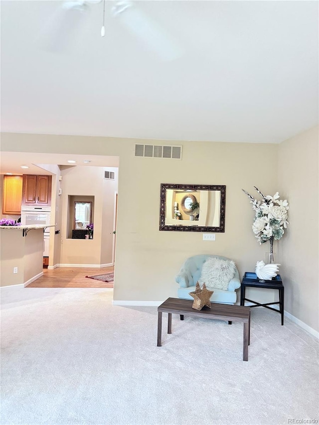 living area with light colored carpet