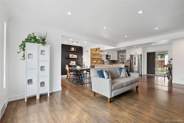 living area featuring baseboards, recessed lighting, and dark wood-type flooring