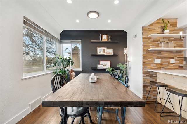 dining area featuring wood-type flooring, baseboards, and visible vents