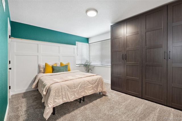 carpeted bedroom with a textured ceiling