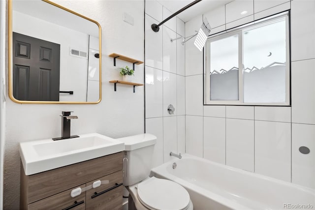 bathroom with visible vents, toilet, vanity, and shower / washtub combination