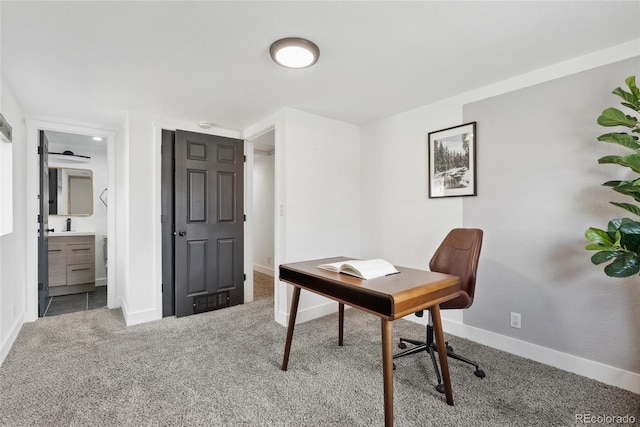 carpeted office featuring baseboards