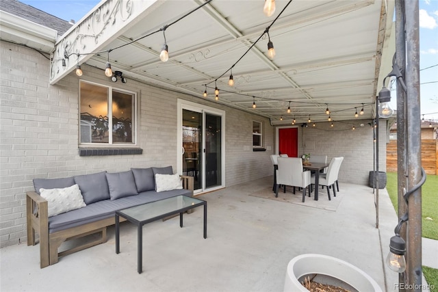 view of patio / terrace featuring outdoor lounge area, outdoor dining space, and fence