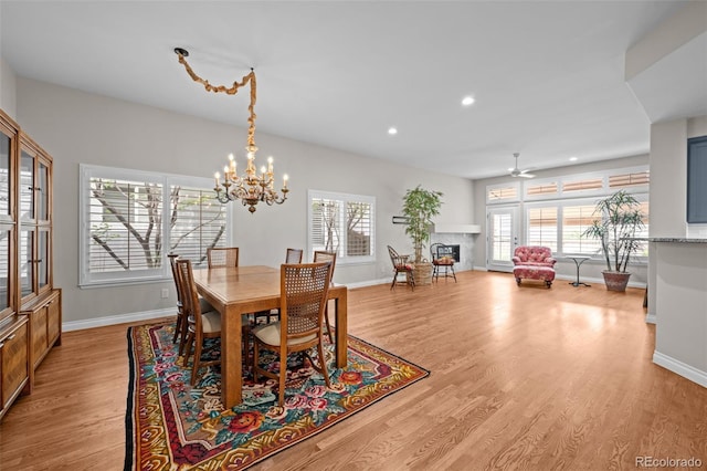 6900 W Grant Ranch Blvd Unit 88, Denver, CO 80123 - dining room featuring baseboards, a fireplace, light wood-type flooring, recessed lighting, and a ceiling fan