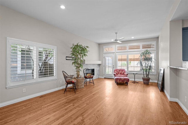 6900 W Grant Ranch Blvd Unit 88, Denver, CO 80123 - living area featuring a lit fireplace, a ceiling fan, light wood-style flooring, baseboards, and recessed lighting