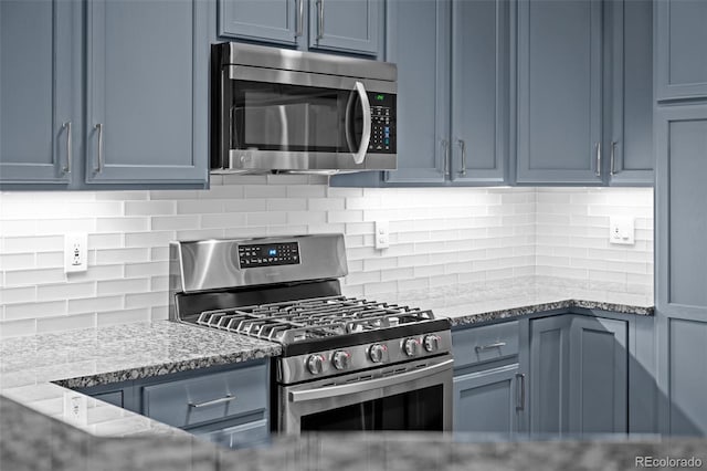 6900 W Grant Ranch Blvd Unit 88, Denver, CO 80123 - kitchen with stainless steel appliances, blue cabinetry, and tasteful backsplash