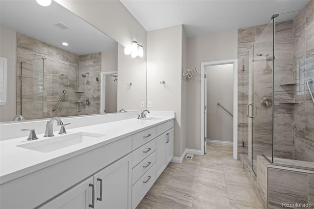 6900 W Grant Ranch Blvd Unit 88, Denver, CO 80123 - full bath with double vanity, a shower stall, marble finish flooring, and baseboards
