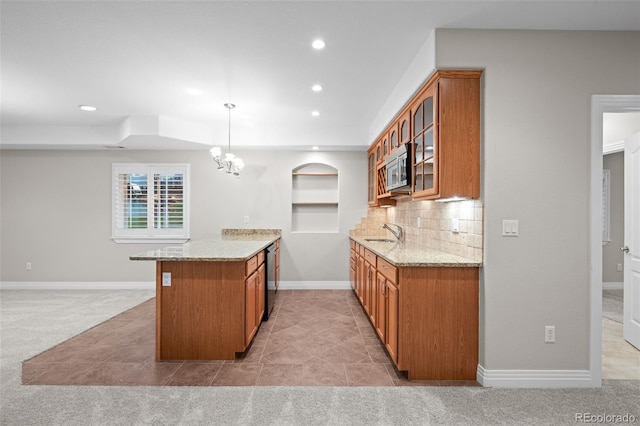 6900 W Grant Ranch Blvd Unit 88, Denver, CO 80123 - kitchen featuring brown cabinetry, a sink, light stone countertops, and recessed lighting