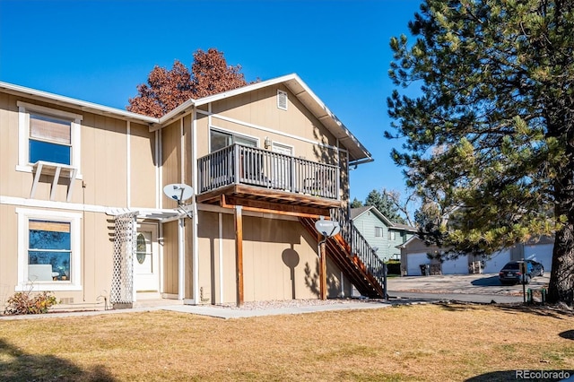 2105 Coronado Pkwy Unit C, Denver, CO 80229 - rear view of house featuring a lawn, stairs, and a balcony