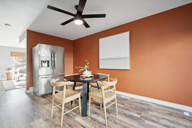 dining room with ceiling fan, baseboards, and wood finished floors