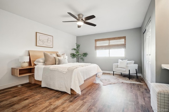 bedroom with a ceiling fan, a closet, baseboards, and wood finished floors