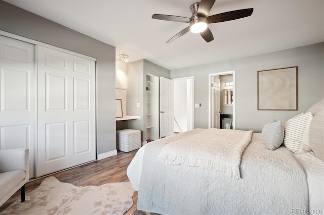 2105 Coronado Pkwy Unit C, Denver, CO 80229 - bedroom featuring wood finished floors, ensuite bathroom, a closet, and a ceiling fan
