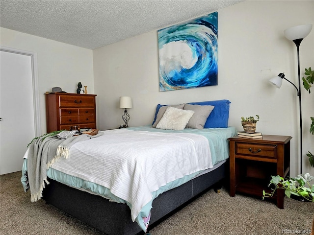 bedroom featuring carpet floors and a textured ceiling