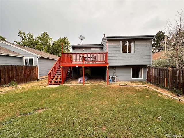 rear view of property with a yard and a wooden deck