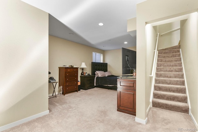 bedroom with baseboards, recessed lighting, and light colored carpet