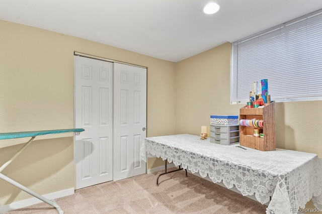 carpeted home office featuring baseboards