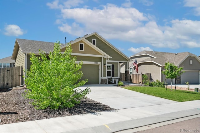 8339 Mosby Way, Colorado Springs, CO 80908 - view of front of house featuring driveway, stone siding, and a garage