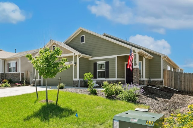 8339 Mosby Way, Colorado Springs, CO 80908 - view of front facade with stone siding, an attached garage, and driveway