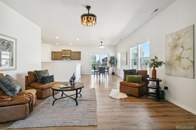 8339 Mosby Way, Colorado Springs, CO 80908 - living area featuring light wood-type flooring, a chandelier, and recessed lighting