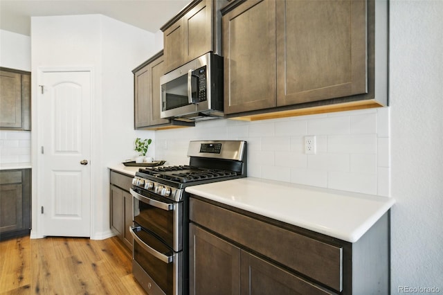 8339 Mosby Way, Colorado Springs, CO 80908 - kitchen with appliances with stainless steel finishes, light wood finished floors, tasteful backsplash, and light countertops