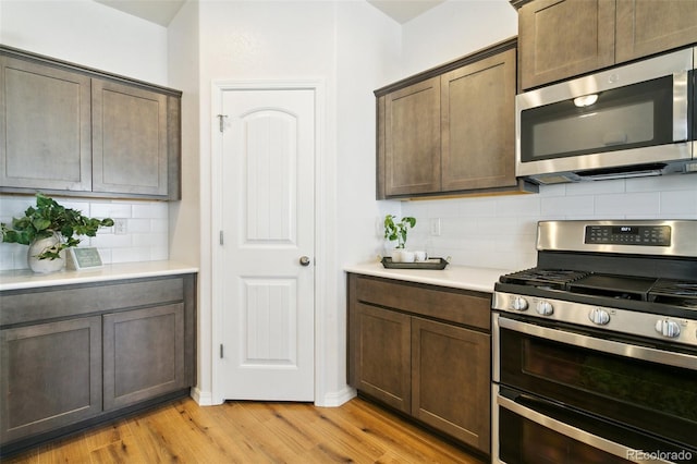 8339 Mosby Way, Colorado Springs, CO 80908 - kitchen featuring stainless steel appliances, light wood finished floors, tasteful backsplash, and light countertops