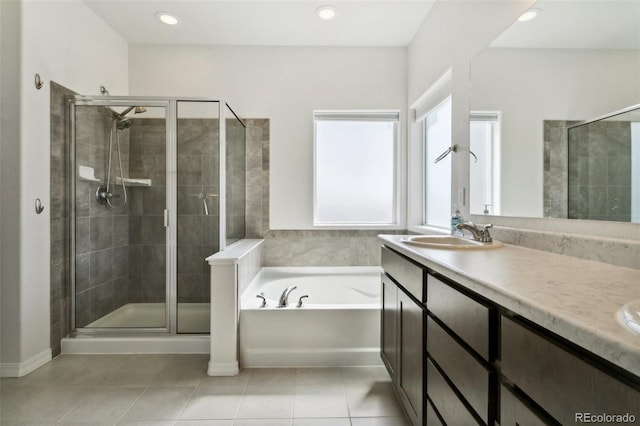 8339 Mosby Way, Colorado Springs, CO 80908 - bathroom featuring a bath, a shower stall, tile patterned flooring, double vanity, and recessed lighting